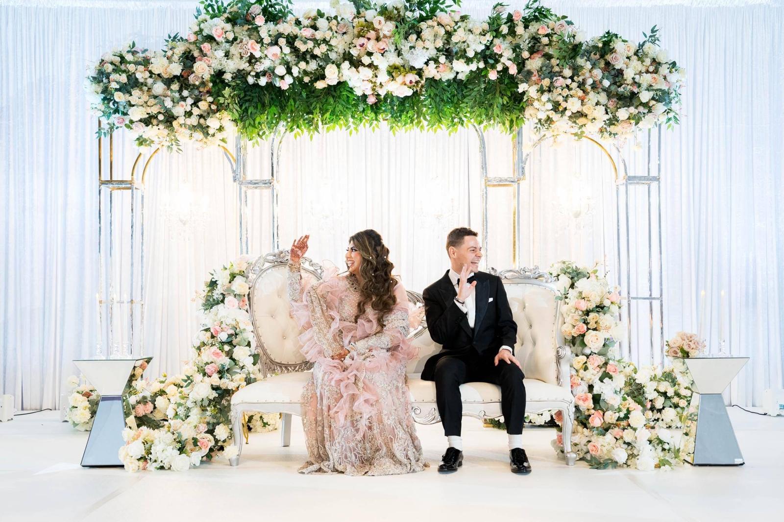Yamal wedding stage with abundant ivory flowers and elegant event styling